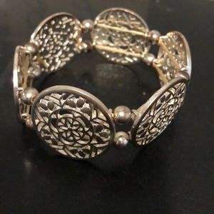 Francesca’s silver tone filigree disc bracelet.